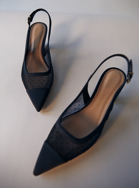 Pair of black slingback kitten heels called 'Snipped', with mesh material and polka dots by Russell and Bromley