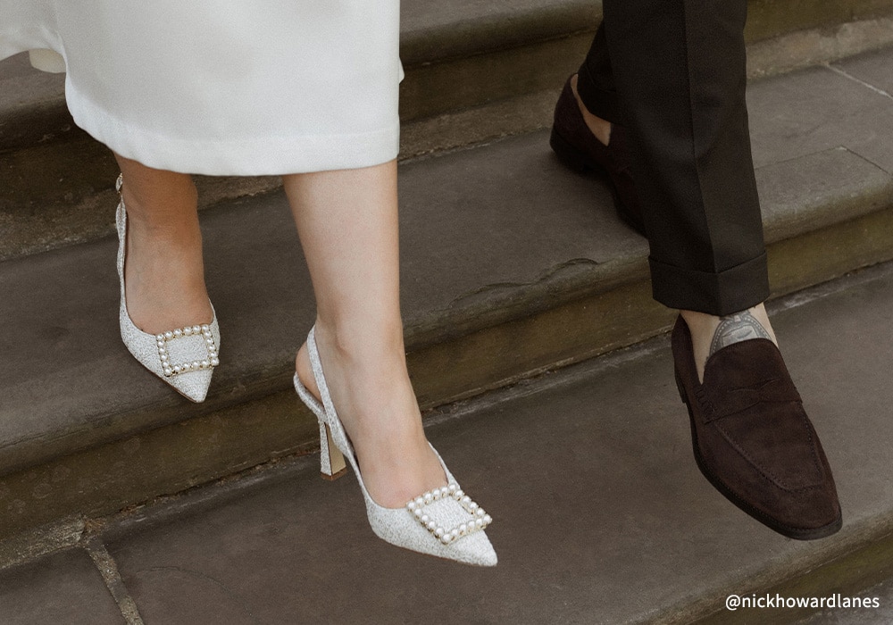 Close up on bride and groom's wedding shoes
