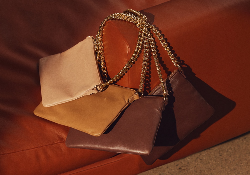4 Russell and Bromley bags on leather sofa